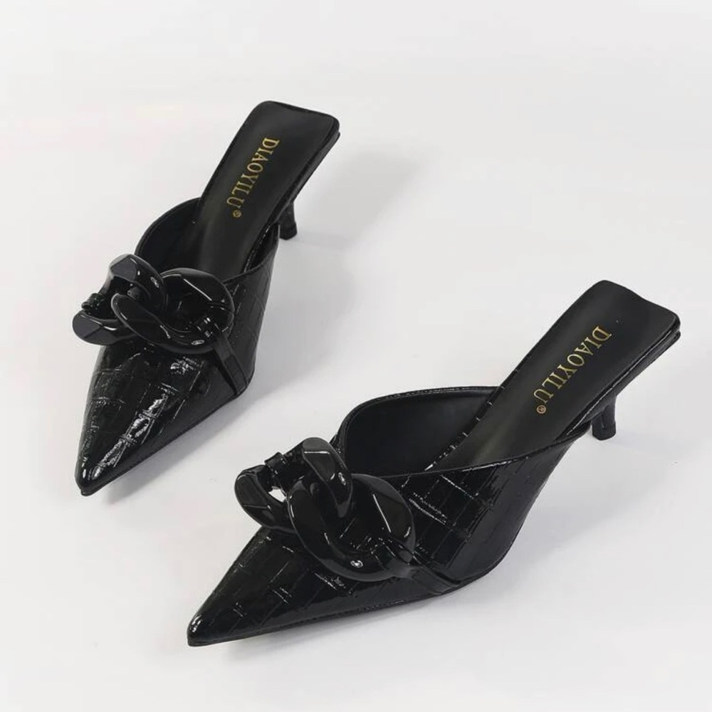 Black heels. PU Leather  outsole material is  rubber.